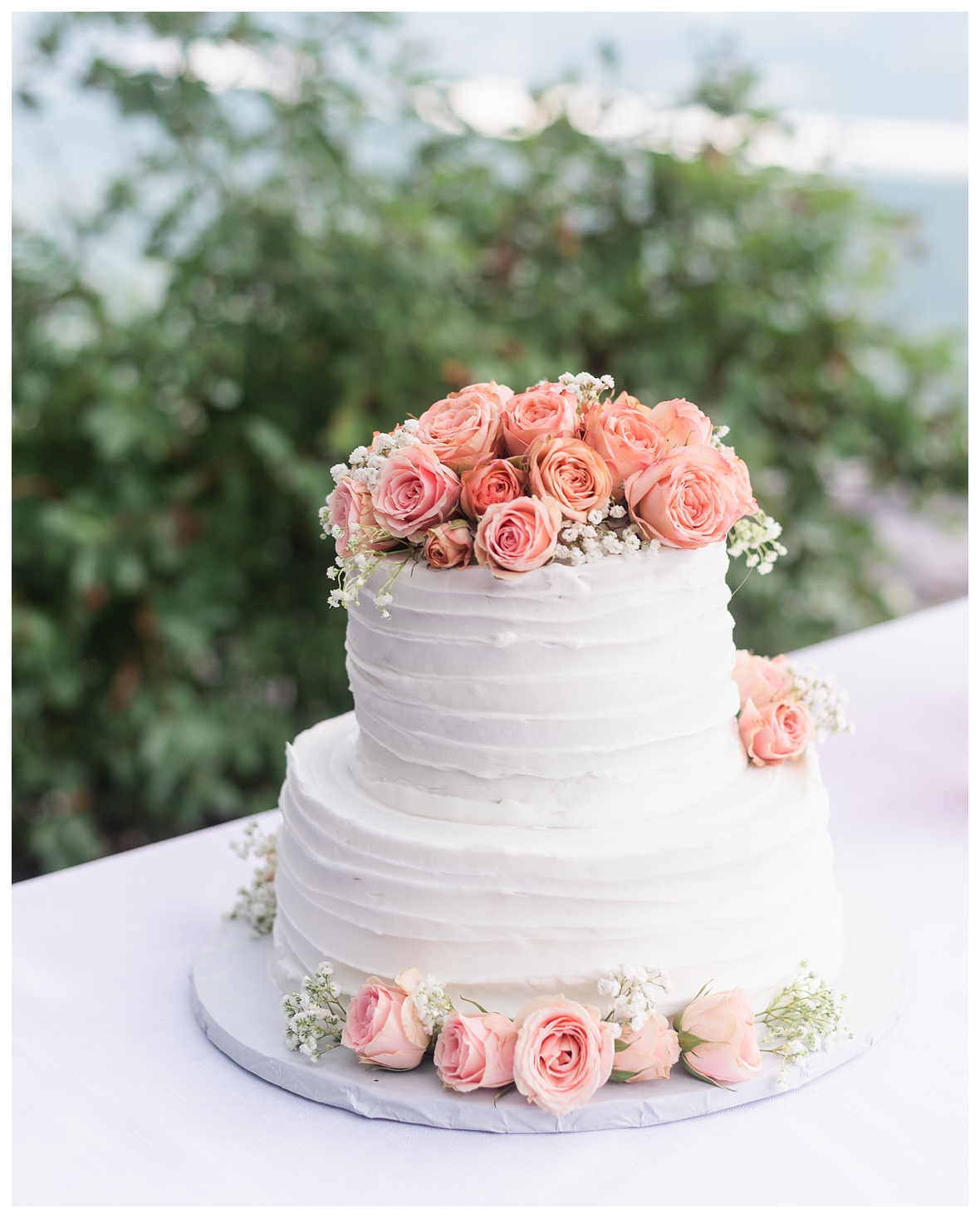 white cake with pink roses