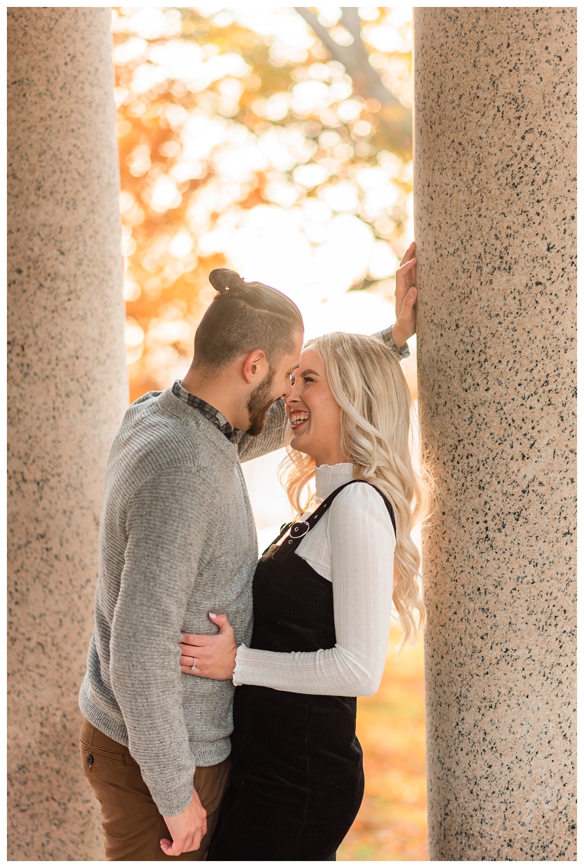 couple snuggles and laughs for engagement photos