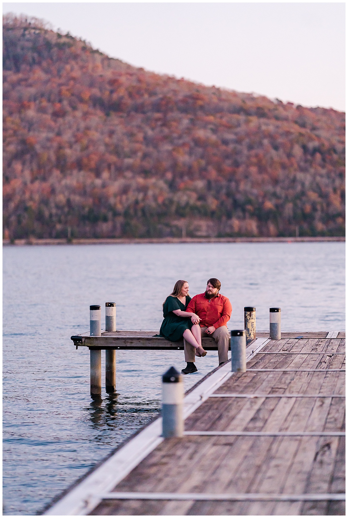 Fall Engagement Couple Sitting on Pier